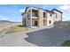 Modern two-story home exterior with stone accents, balconies, and landscaped yard at 5741 Doc Bar Circle, Larkspur, CO 80118