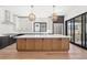 Beautiful kitchen features a large island with modern lighting and stainless steel appliances at 5741 Doc Bar Circle, Larkspur, CO 80118