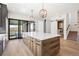 Open kitchen offers a large island, stainless appliances, modern lighting, and easy access to an outdoor living space at 5741 Doc Bar Circle, Larkspur, CO 80118