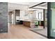 Spacious modern kitchen features stainless appliances, stone counters, and hardwood floors at 5741 Doc Bar Circle, Larkspur, CO 80118