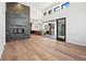 Open-concept living room with fireplace and doors leading to an outdoor living space at 5741 Doc Bar Circle, Larkspur, CO 80118