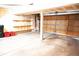 Large unfinished garage with a concrete floor, exposed drywall, and a roll-up door at 2090 S Hannibal Way # C, Aurora, CO 80013