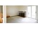 Carpeted living room featuring a brick fireplace, a sliding glass door to a balcony and a small step-up at 2090 S Hannibal Way # C, Aurora, CO 80013