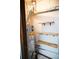 Compact utility room with water heater, pipes, and wooden shelves along the wall for convenient storage at 2090 S Hannibal Way # C, Aurora, CO 80013