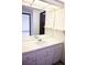 Bright vanity with white cabinets, decorative knobs, large mirror, and shelves at 2090 S Hannibal Way # C, Aurora, CO 80013