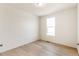 Simple bedroom with large window and wood-look flooring at 13352 E 110Th Way, Commerce City, CO 80022