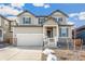 Two-story house with gray siding, white trim, and a two-car garage at 13352 E 110Th Way, Commerce City, CO 80022