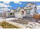 Two-story house on a tree-lined street with a gravel driveway at 13352 E 110Th Way, Commerce City, CO 80022