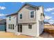Two-story house with light beige siding and a backyard at 13352 E 110Th Way, Commerce City, CO 80022
