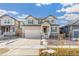 Two-story house with attached garage and front yard at 13352 E 110Th Way, Commerce City, CO 80022