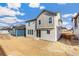 Two-story house with light beige siding, showcasing the backyard at 13352 E 110Th Way, Commerce City, CO 80022