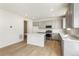 Bright kitchen featuring gray cabinets, an island, and white countertops at 13352 E 110Th Way, Commerce City, CO 80022