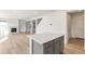 Island kitchen with gray cabinets and view into living room and fireplace at 13352 E 110Th Way, Commerce City, CO 80022