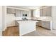 Open kitchen with gray cabinets, island, and stainless steel appliances at 13352 E 110Th Way, Commerce City, CO 80022