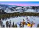 Aerial view of luxury cabin, pool, and mountain landscape with evergreen trees at 250 Sallie Barber Rd, Breckenridge, CO 80424