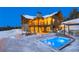 Exterior view of a luxury home featuring a hot tub, fire pit, and outdoor seating area at 250 Sallie Barber Rd, Breckenridge, CO 80424