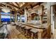 Wet bar with wood countertop, wooden cabinetry, mountain views, and seating at 250 Sallie Barber Rd, Breckenridge, CO 80424