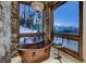 Bathroom with copper tub and mountain views at 250 Sallie Barber Rd, Breckenridge, CO 80424