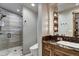 This well lit bathroom has a glass enclosed shower, granite countertops and dark wood cabinetry at 250 Sallie Barber Rd, Breckenridge, CO 80424