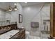 This bathroom features a glass shower, floating granite countertop and light fixtures at 250 Sallie Barber Rd, Breckenridge, CO 80424