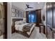 This bedroom has plush bedding, mountain views from the window, and dark wood accents at 250 Sallie Barber Rd, Breckenridge, CO 80424