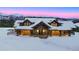 Snow-covered mountain home featuring timber frame accents and stone entryway at 250 Sallie Barber Rd, Breckenridge, CO 80424