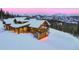 Stunning mountain home with snow-covered roof, stone accents and view of ski runs at 250 Sallie Barber Rd, Breckenridge, CO 80424