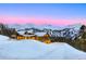 Beautiful exterior of mountain home with snow covered roof, stone accents, and mountain view at 250 Sallie Barber Rd, Breckenridge, CO 80424