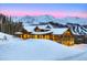 Inviting timber framed mountain home with snowy landscape and majestic mountain backdrop at 250 Sallie Barber Rd, Breckenridge, CO 80424