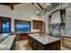 Gourmet kitchen with large island, granite countertops, and custom cabinetry at 250 Sallie Barber Rd, Breckenridge, CO 80424