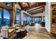 Sitting area boasts vaulted wood ceilings, mountain views, and leads into the dining area and wet bar at 250 Sallie Barber Rd, Breckenridge, CO 80424