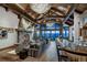 Living room showcasing stone fireplace, wooden beams, vaulted ceilings, bar area, and mountain views at 250 Sallie Barber Rd, Breckenridge, CO 80424