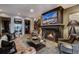 This living room boasts a grand fireplace, leather furniture, and mountain views at 250 Sallie Barber Rd, Breckenridge, CO 80424