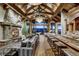 Spacious living room featuring stone fireplace, wood beams, vaulted ceilings, bar area, and scenic mountain views at 250 Sallie Barber Rd, Breckenridge, CO 80424