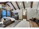 This bedroom features a vaulted ceiling with wood beams, and an ensuite bathroom with a wood vanity at 250 Sallie Barber Rd, Breckenridge, CO 80424