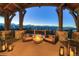 Outdoor patio area featuring a stone fireplace, seating and mountain views at 250 Sallie Barber Rd, Breckenridge, CO 80424