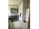 Spacious bathroom with double vanity, great mirror and gray and white tile at 47904 Dartmouth Ave, Bennett, CO 80102