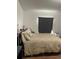 Cozy bedroom with soft lighting, neutral tones, and comfortable bedding at 47904 Dartmouth Ave, Bennett, CO 80102