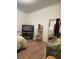 Bedroom with a TV and laminate wood floors; natural light coming in from the window at 47904 Dartmouth Ave, Bennett, CO 80102