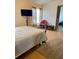 Bright bedroom features a metal frame bed, natural light, and hardwood floors at 47904 Dartmouth Ave, Bennett, CO 80102