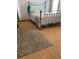 Bedroom featuring a metal frame bed, hardwood floors, and natural light at 47904 Dartmouth Ave, Bennett, CO 80102