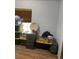 Bedroom with wood floors and closet with items stored in plastic tubs at 47904 Dartmouth Ave, Bennett, CO 80102
