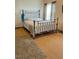 Comfortable bedroom with wood floors and a metal frame bed at 47904 Dartmouth Ave, Bennett, CO 80102