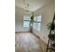 Bright dining room featuring a modern light fixture, window views, and attractive floors at 47904 Dartmouth Ave, Bennett, CO 80102