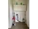 Laundry area featuring cabinets, exposed washer hookups, and cleaning supplies at 47904 Dartmouth Ave, Bennett, CO 80102