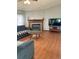 Comfortable living room showcasing a fireplace, wood floors, and a TV, perfect for relaxing at 47904 Dartmouth Ave, Bennett, CO 80102