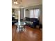 Inviting living room featuring hardwood floors, a comfortable sofa, and a stylish glass coffee table at 47904 Dartmouth Ave, Bennett, CO 80102