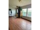 Bright living room with beautiful hardwood floors, lots of natural light and a rustic bookshelf at 47904 Dartmouth Ave, Bennett, CO 80102