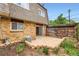 A quaint brick patio area with partial fencing, some grass and side access at 6727 S Race St, Centennial, CO 80122