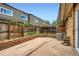 A backyard patio with brick trim, wooden fence, and glimpses of the home's exterior at 6727 S Race St, Centennial, CO 80122